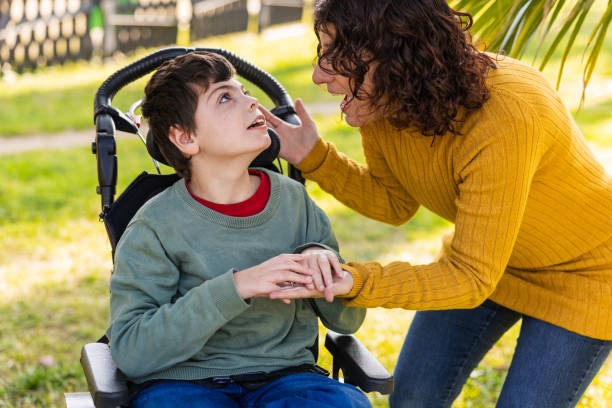 Un jeune homme personne dépendant dans son fauteuil roulant est en tête à tête avec une personne aidante avec bienveillance et écoute au quotidien